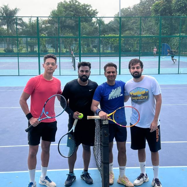 Four players at the net after a morning match