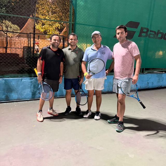 A group on court under floodlights